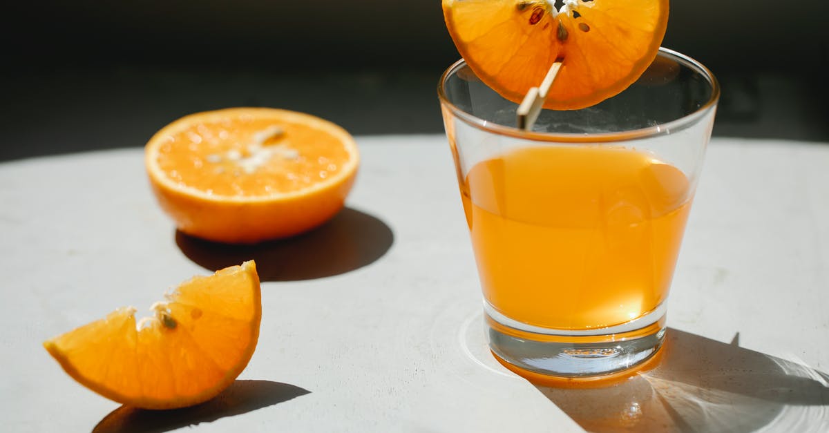 How do I concentrate the flavor in orange juice? - Palatable fresh juicy orange cut in slices with transparent glass of orange juice