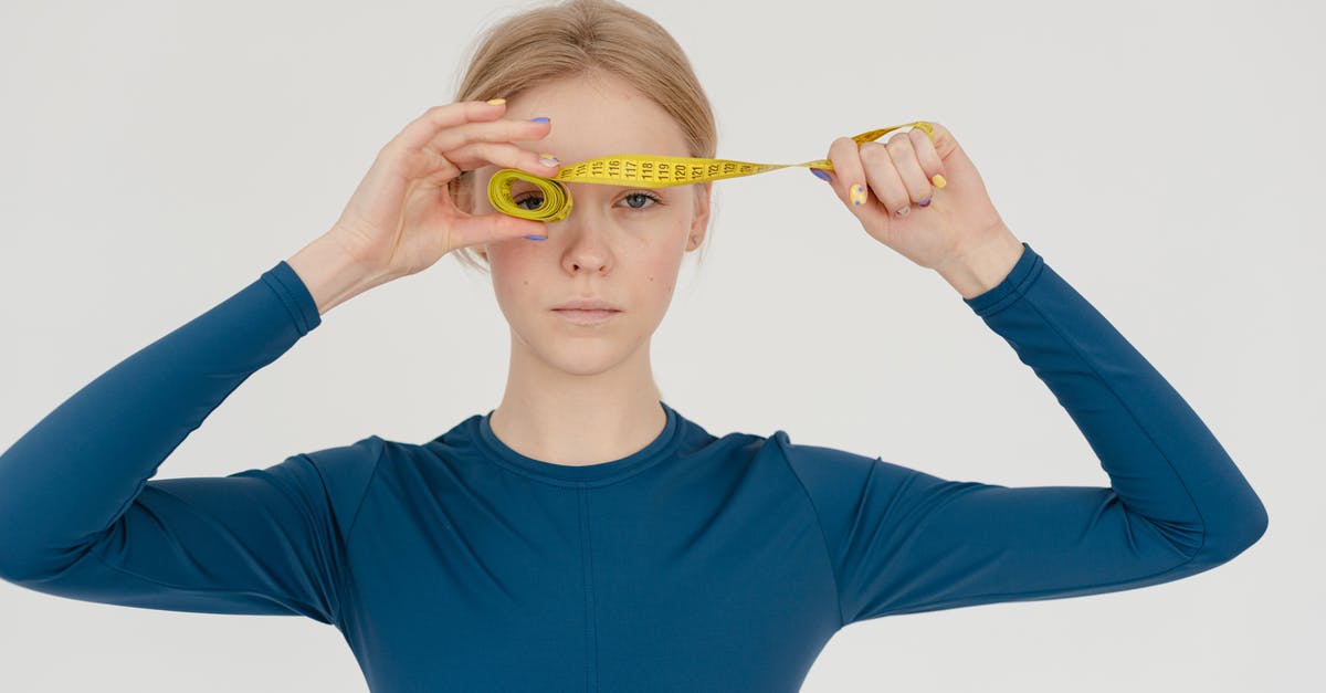 How do I control the shape of my spheres? - Serious woman with rolled measuring tape in studio