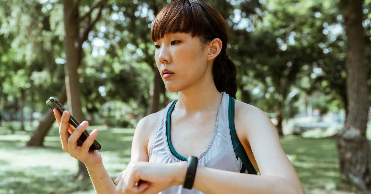 How do I control the shape of my spheres? - Concentrated young Asian woman using smartphone in park