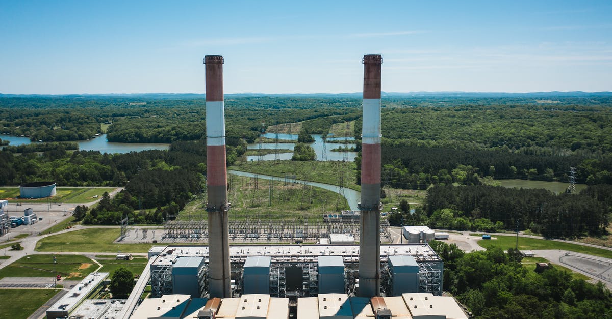 How do I control the smoke from a chimney starter? - Industrial chimneys on power plant platform under sky