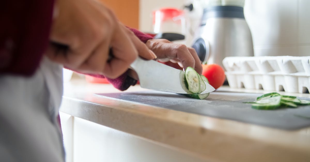 How do I easily get thin slices of guava paste? - A Person Slicing a Cucumber