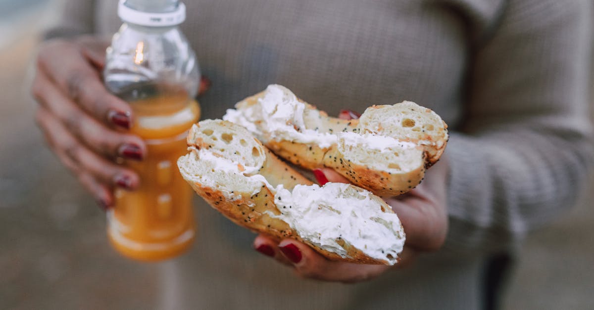 How do I fix crystallized butter cream filling made with ghee? - A Person Holding a Creamy Donut and Orange Juice