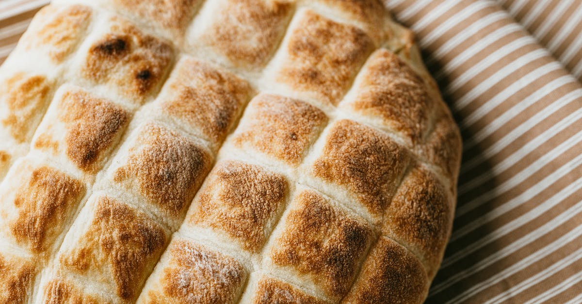 How do I get crispy but thin bread crust? - Delicious homemade bread on rustic tablecloth