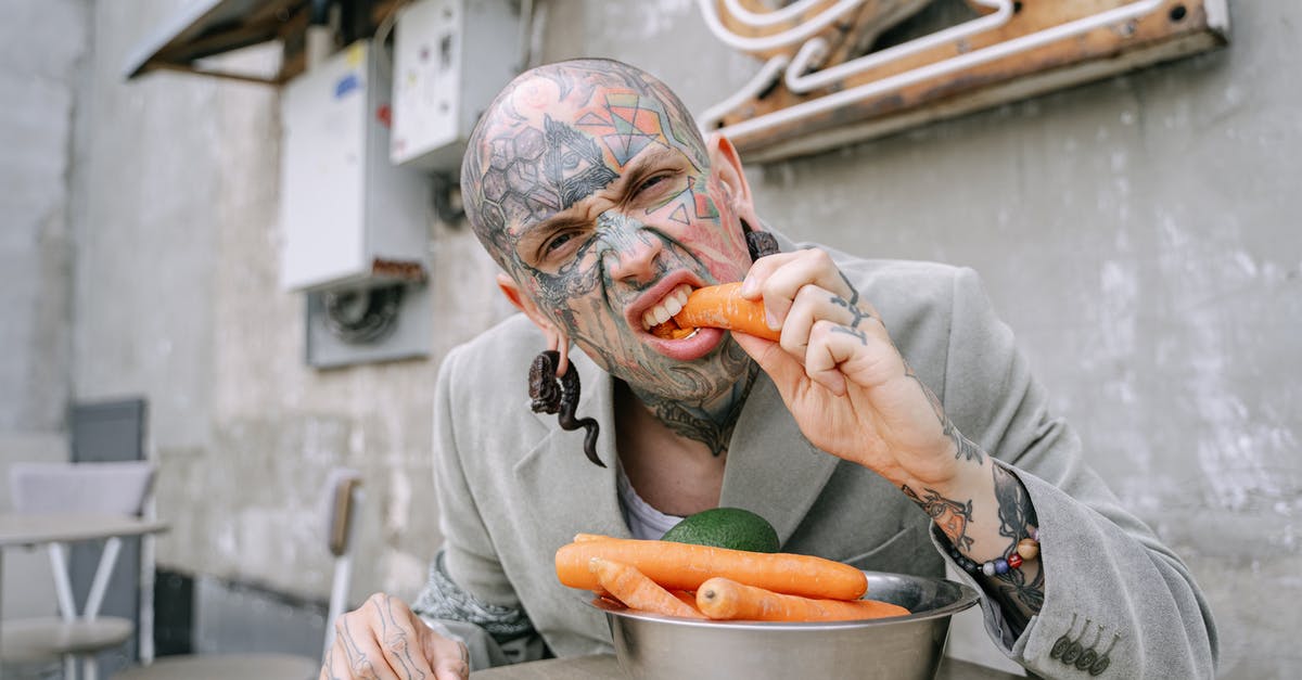 How do I get vegetarian tamales to come out fluffy? - Person in Gray Long Sleeve Shirt Holding Brown and White Ceramic Bowl With Sliced Orange Fruit