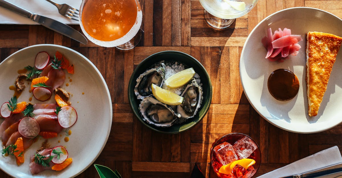 How do I keep cake from collapsing when adding lemon juice? - Top view of assorted cocktails and bowl of oysters served on wooden table near plate of fresh raw sliced fish and yummy dessert