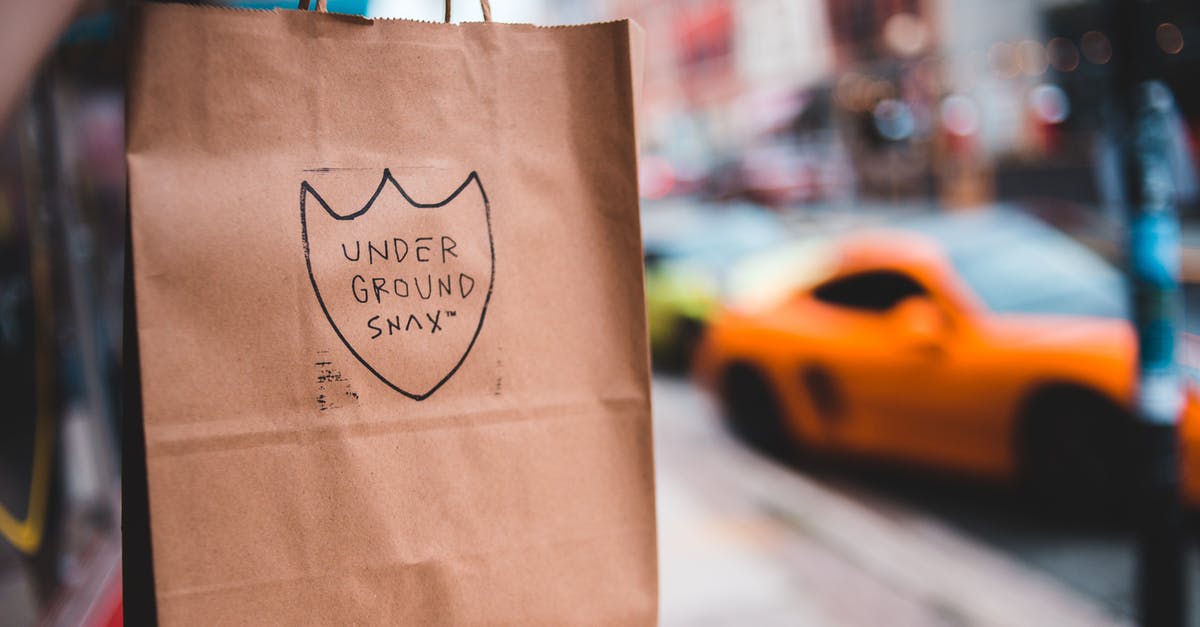 How do I label already-frozen bags? - Paper bag with label on blurred background of pavement near road with cars