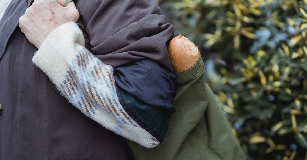 How do I maintain the crunchy crust of home baked bread? - Crop woman with bread in fabric bag outdoors