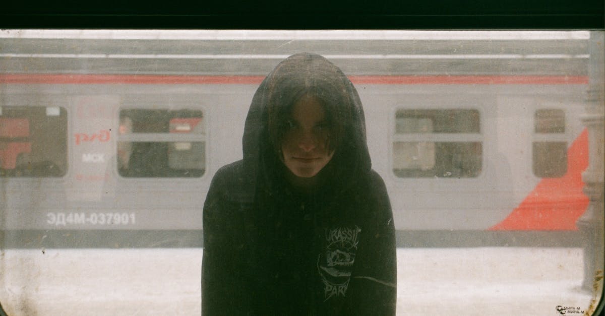 How do I make authentic Russian black bread? - Hooded Unrecognizable Young Person Standing on Platform at Train Window