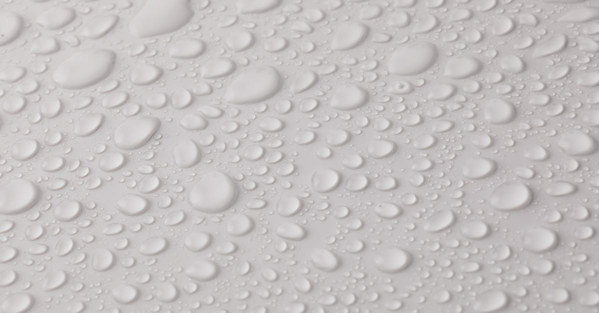 How do I make even layers of puree for dehydrator? - Closeup top view of plain wet abstract surface with small dripped water drops of different shapes placed on white background