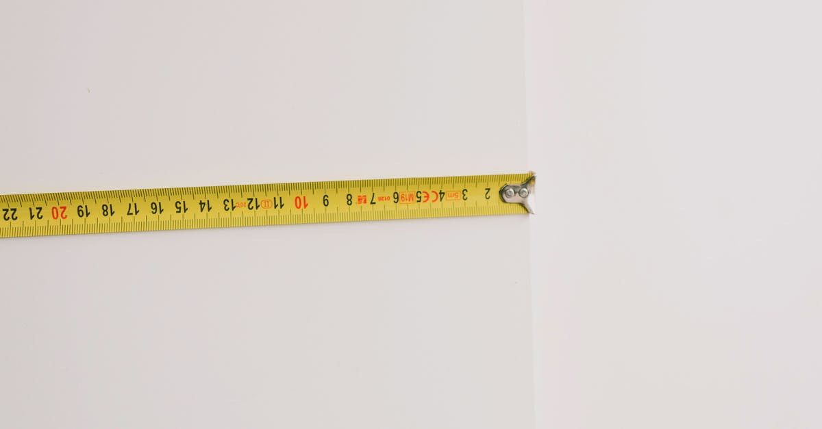 How do I measure the ripeness of my tomatoes? - Measuring tape on empty white background