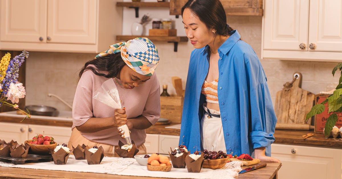 How do I practice piping icing without wasting icing and money? - Women Preparing Cupcakes in the Kitchen