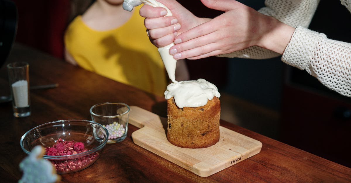 How do I practice piping icing without wasting icing and money? - Person Holding Piping Bag with White Icing