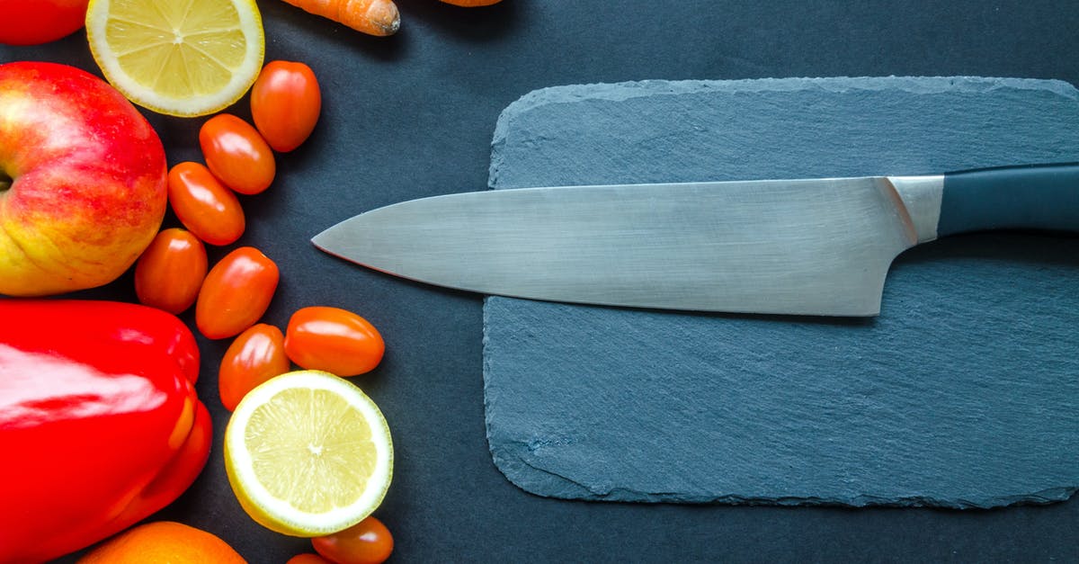 How do I preserve a tomato's freshness after it is cut? - Black Kitchen Knife With Fruits and Vegetable on Table