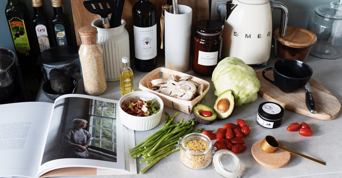 How do I press avocadoes to make avocado oil? - Various colorful healthy food and vegetables locating on countertop next to many different utensils and white kettle during cooking in stylish kitchen