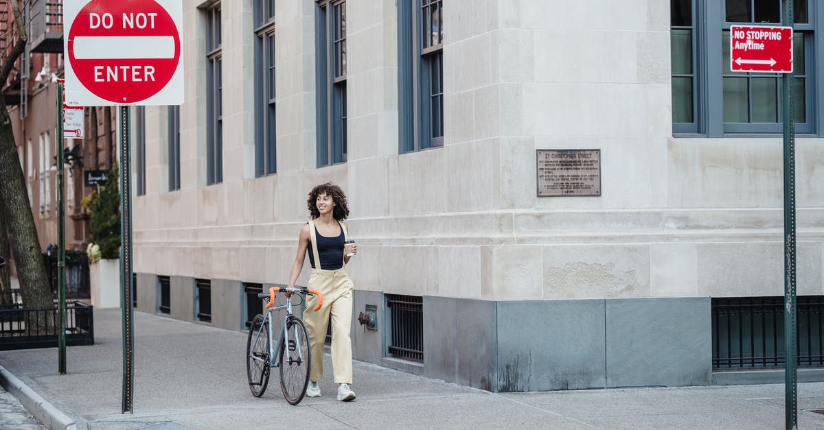 How do I prevent burning when searing in batches? - Contemplative ethnic woman with coffee and bike walking on pavement