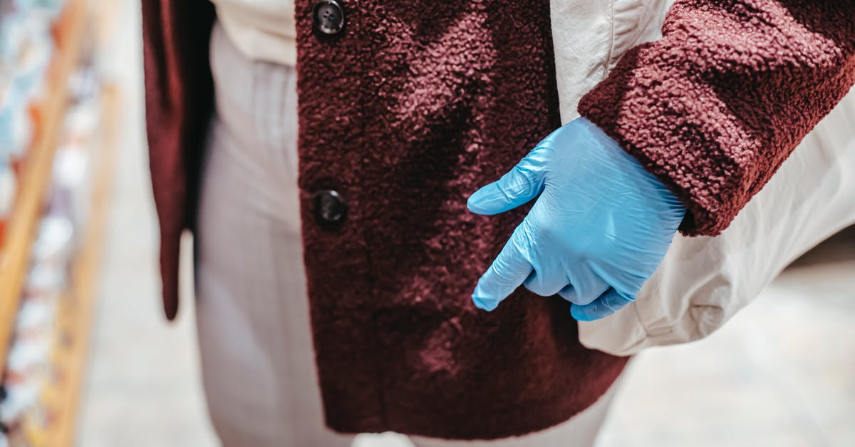 How do I prevent food from sticking to a standard (non-coated) pan? - High angle of crop unrecognizable female client in latex gloves with zero waste shopping bag selecting food in grocery store