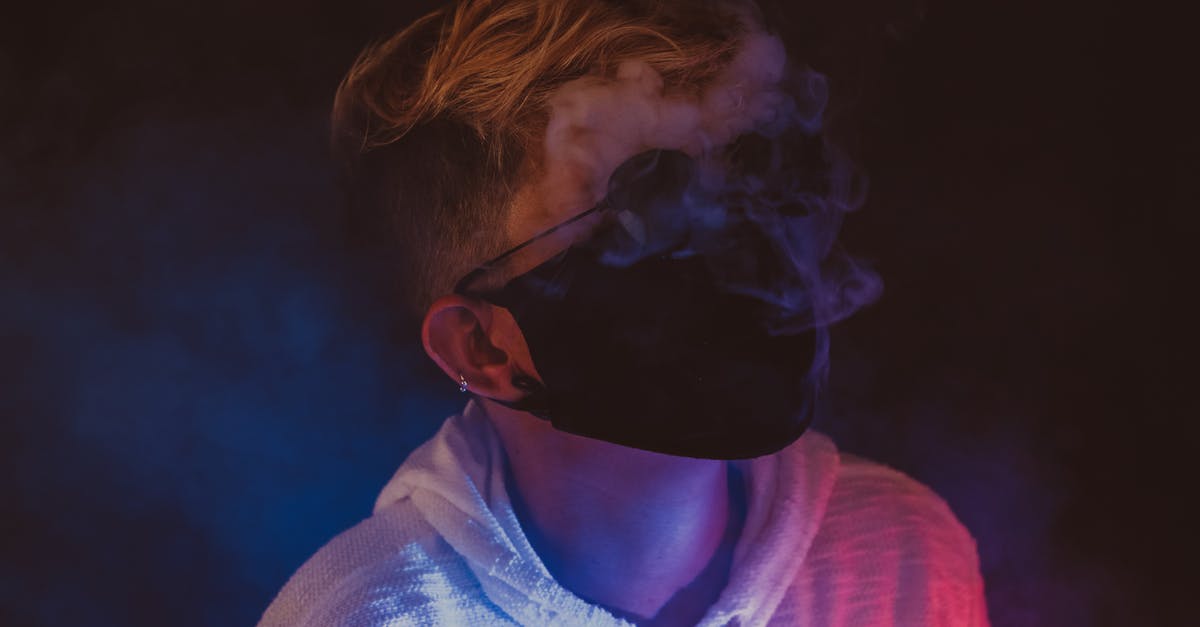 How do I prevent smoke problems indoors? - Confident female in sunglasses and protective mask in room with neon lights and smoke