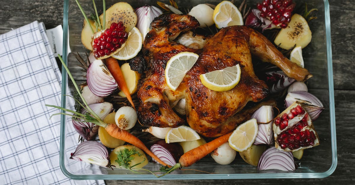 How do I properly cut a chicken breast into strips or chunks? - Delicious roasted chicken with assorted vegetables and fruits on table