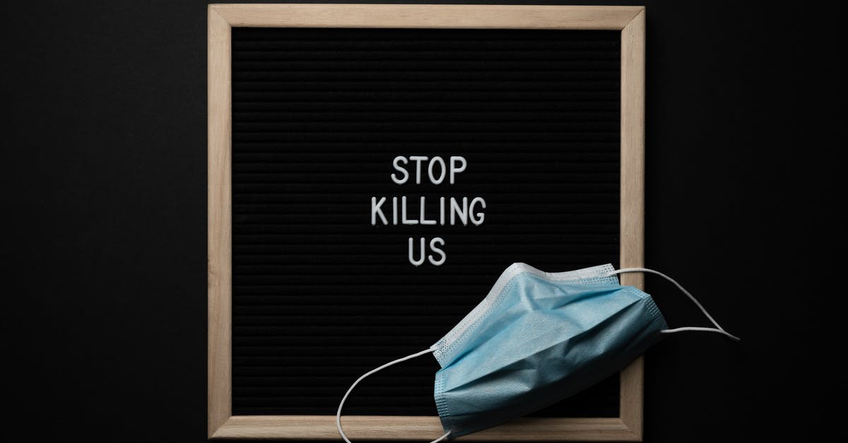 How do I stop onigiri from falling apart? - Top view of composition of blackboard with written phrase STOP KILLING US under mask against black background