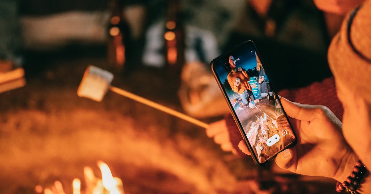 How do I take the heat out of my chili? - Man Recording on His Smartphone Women Roasting Marshmallow