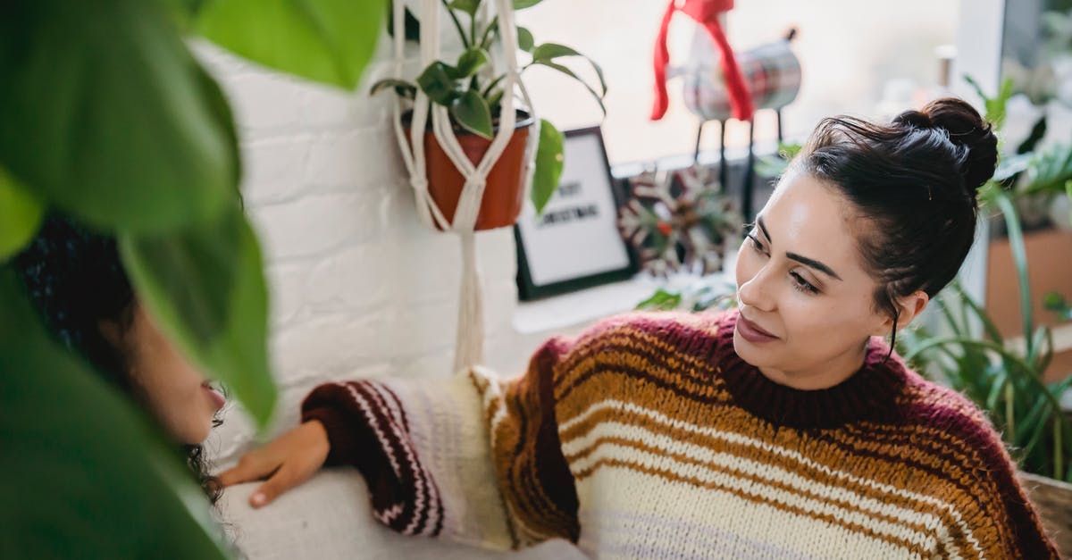 How do I tell guar gum from xanthan? - From above of young female in casual clothes sitting on comfortable couch and talking to friend while resting in cozy room