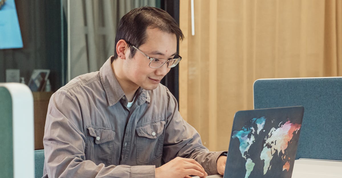 How do I use a Chinese spoon? - A Man in Gray Sleeves Using a Laptop