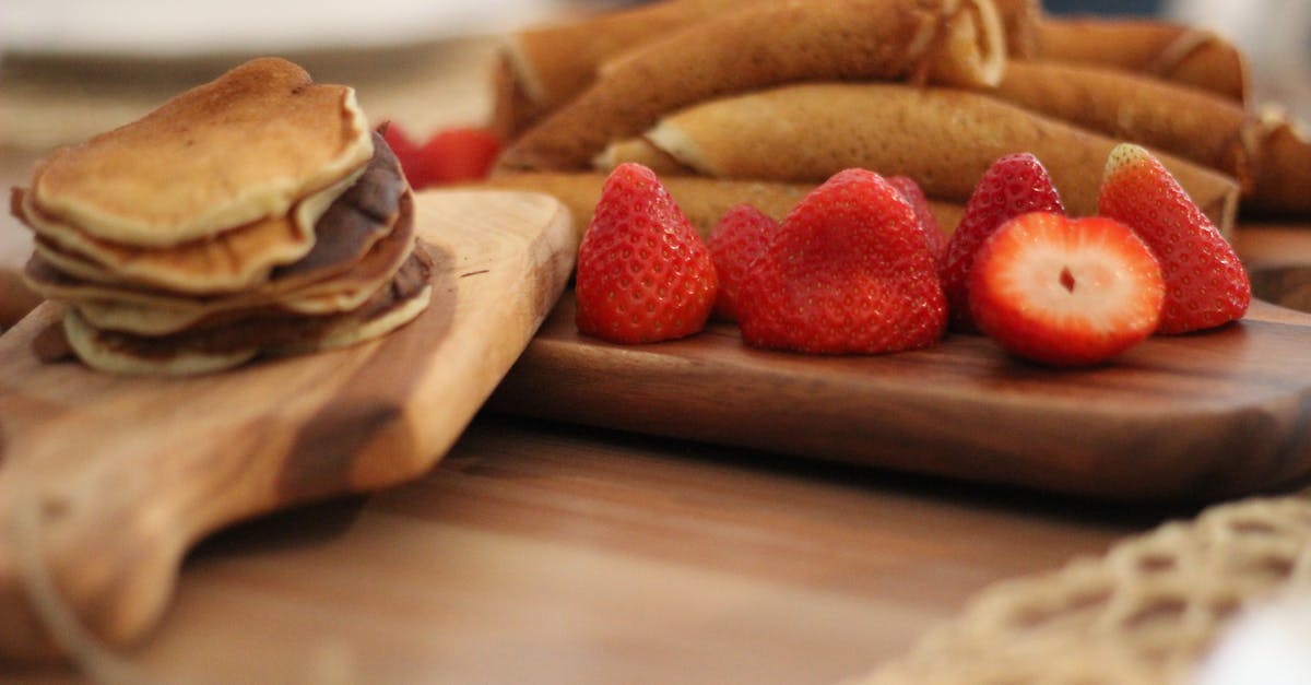 How do the batter and technique differ between crepes and pancakes? - Strawberry Fruit on Brown Wooden Board