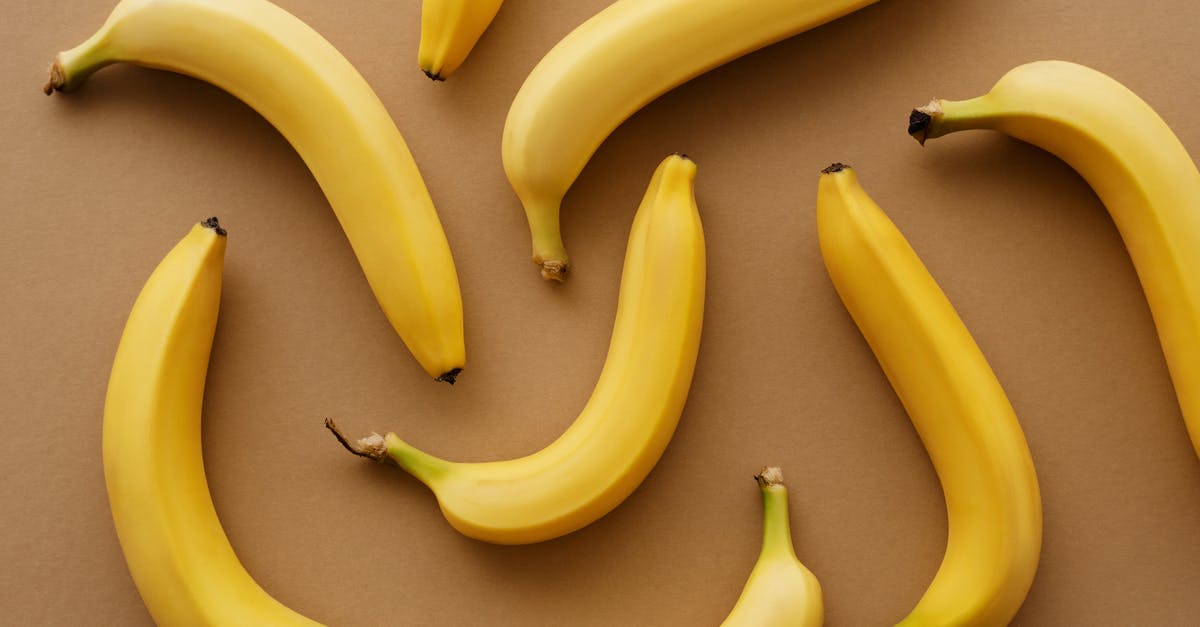 How do the nutritional values of bananas change as they ripen? - Yellow Banana Fruits on Brown Surface