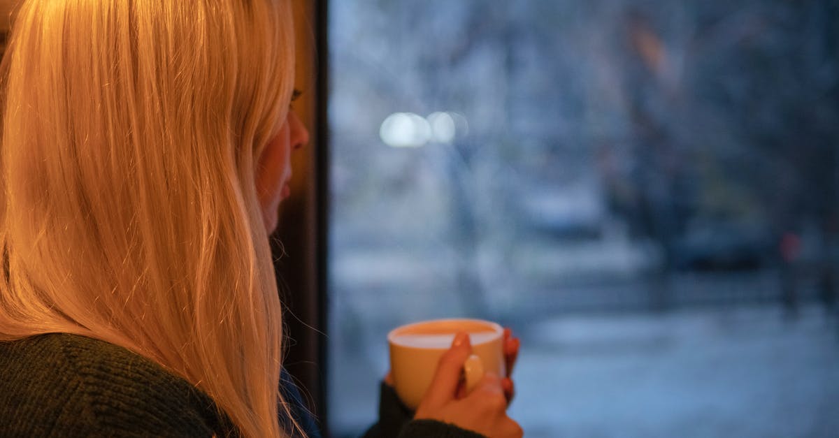 How do they get caffeine out in decaffeinated coffee? - Woman in Black Knit Long-sleeved Shirt Holding White Ceramic Mug