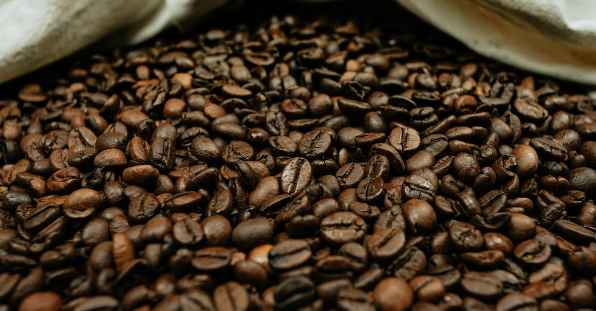 How do we keep our roasted cashews from smelling bad eventually? - Abundance of bright roasted coffee beans near fabric