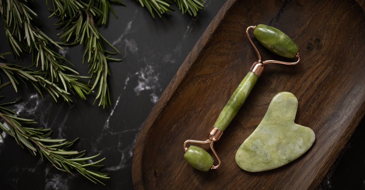 How do you clean a pizza stone? - Facial massager with gua sha on timber tray near rosemary