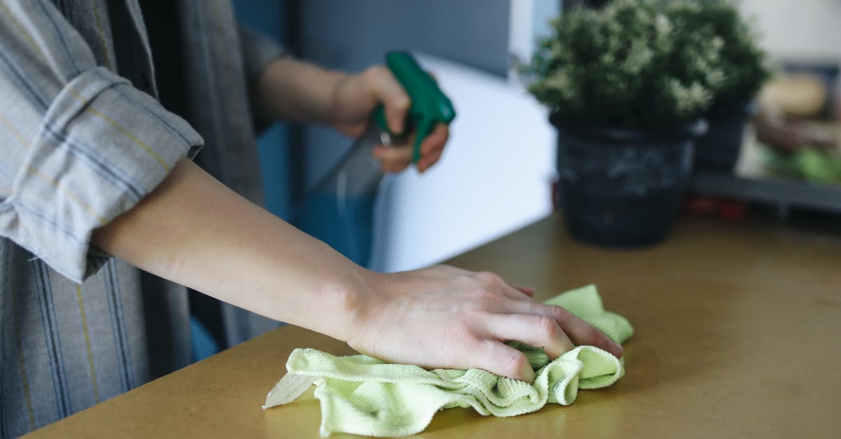 How do you clean cheesecloth? - Person Holding Green Leaf on Brown Wooden Table