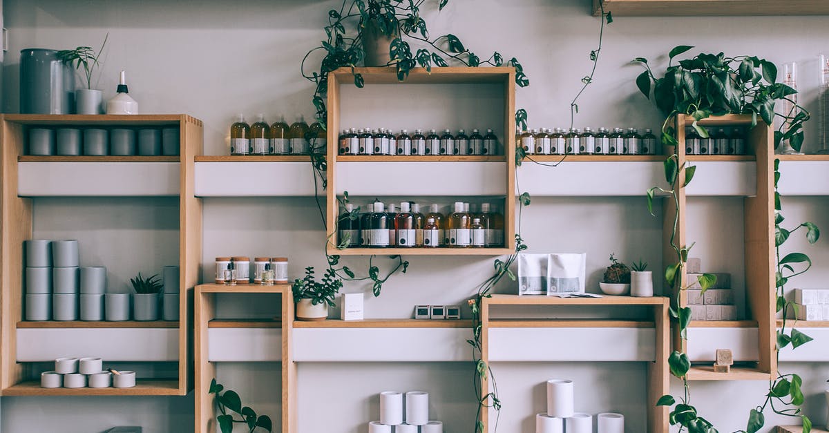 How do you clean cheesecloth full of bean roots? - Creative interior design of small shop with wooden shelves full of assorted colorful bottles and green plants