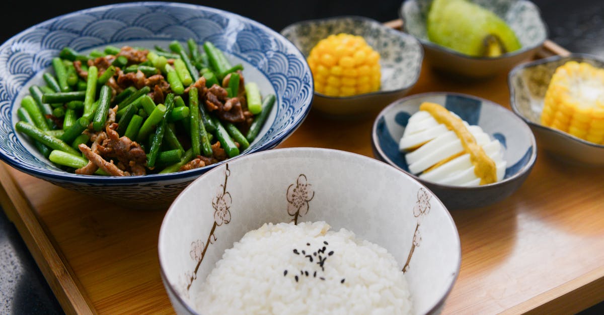 How do you cook corn kernels on BBQ? - Rice on Bowl, Sliced-egg, Corn, and Vegetable on Table