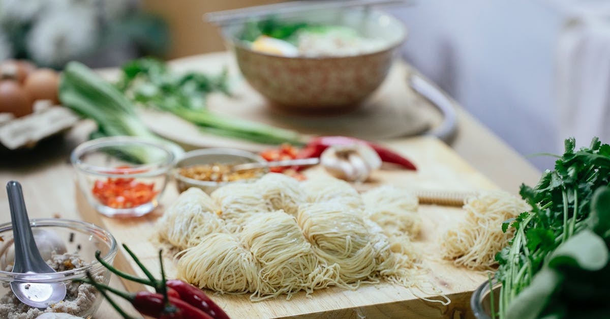 How do you cook flavored pasta? - Composition of uncooked noodles and fresh vegetables on kitchen counter