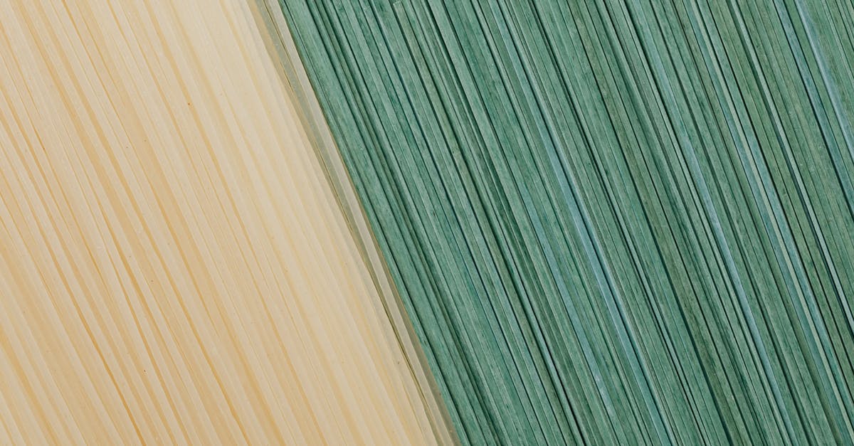 How do you dry homemade pasta so that it stays straight? - Yellow and green food background from dry pasta