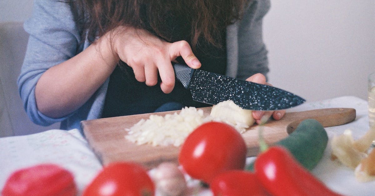 How do you finely dice an onion without crying? [duplicate] - Person Cutting Vegetables on Chopping Board