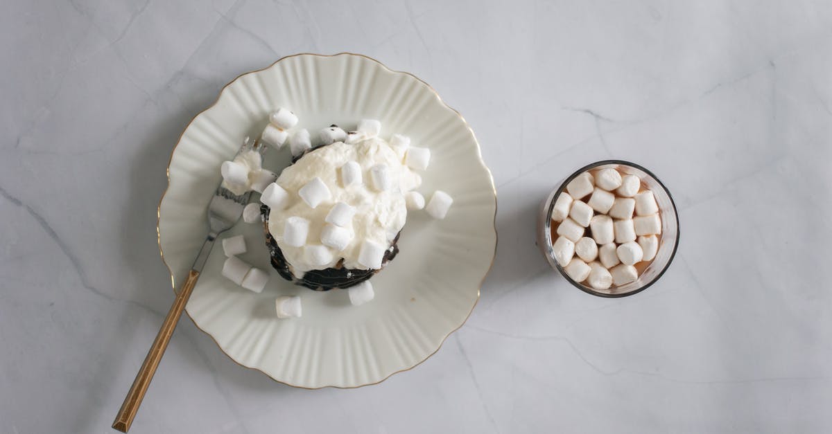 How do you form Marshmallow Ropes? - Top view of plate and fork with delicate white marshmallow and chocolate topping near cocoa