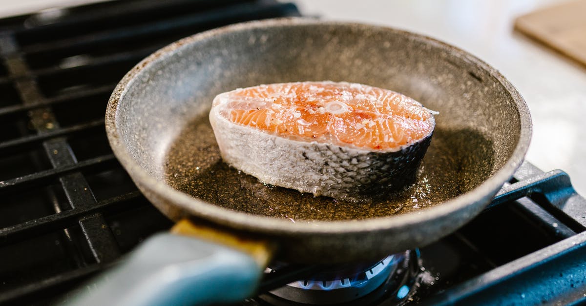 How do you fry a fat, uneven salmon filet? - Close-up of Salmon Cooking in Frying Pan