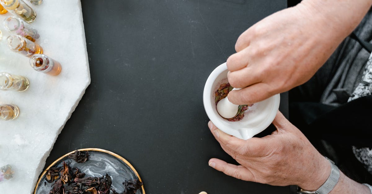 How do you get the smell of fish off your hands? - Person Holding White Ceramic Mug