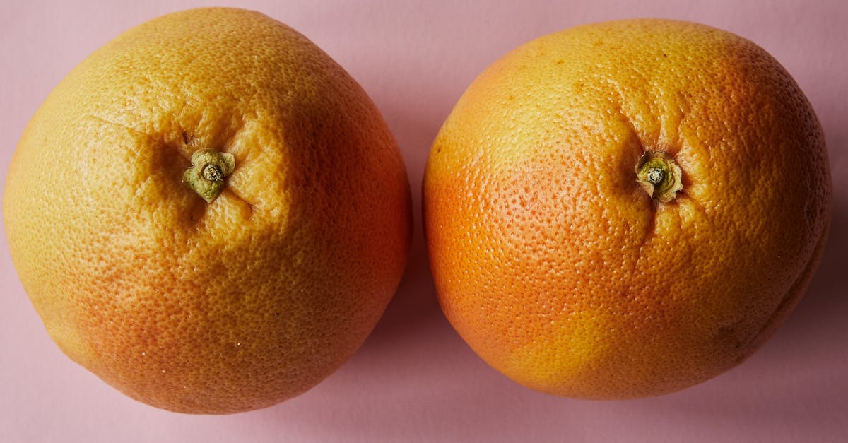 How do you keep chicken breast juicy when grilling? - Ripe oranges placed against pink background