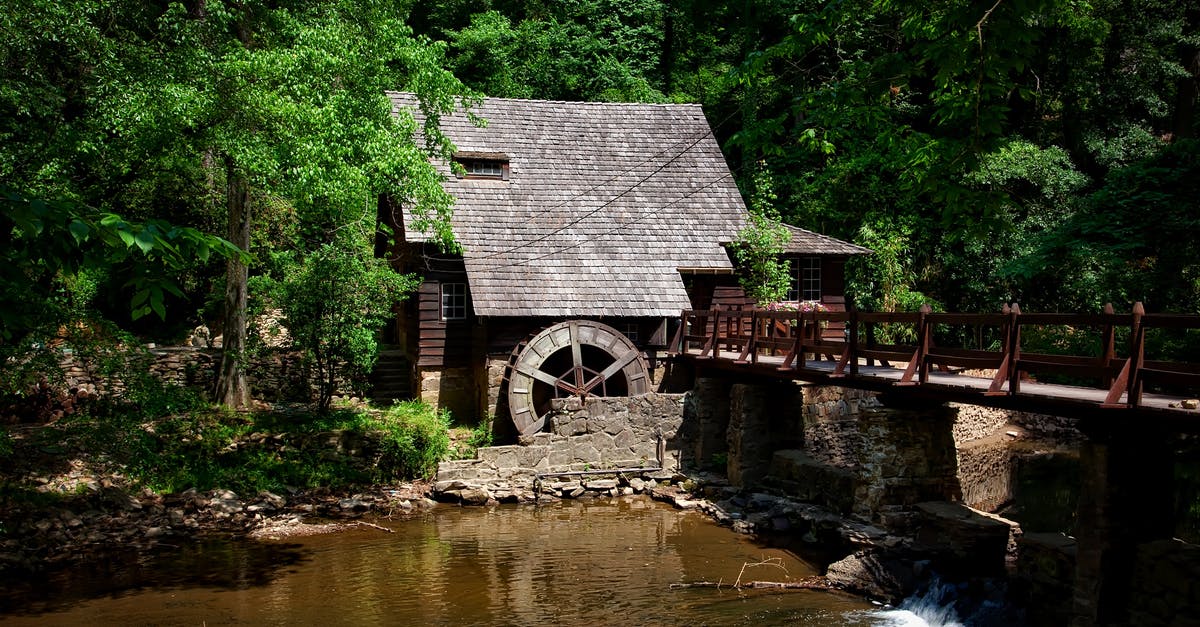 How do you know if stone-ground flour is truly milled with stones? - Brown House Near River Trees and Bridge