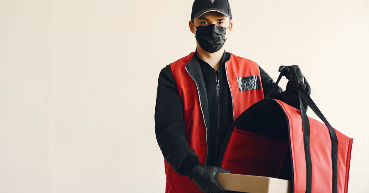 How do you protect a pizza peel? - Young pizza delivery man in uniform and protective mask