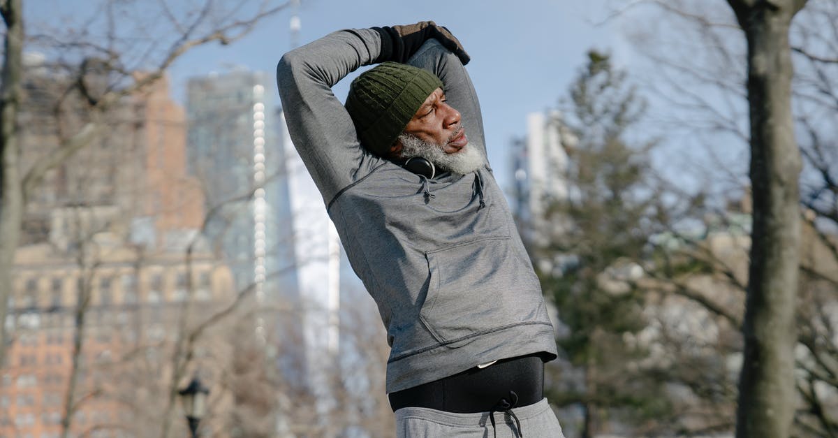 How do you raise your dough in cold seasons? - Senior black male doing exercise in park in fall
