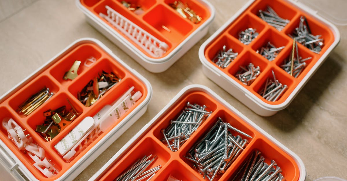 How do you remove the stickiness from reusable plastic container or lid? - From above of boxes with different metal nails and plastic dowels in workshop How do you remove the stickiness from reusable plastic container or lid? - From above of boxes with different metal nails and plastic dowels in workshop