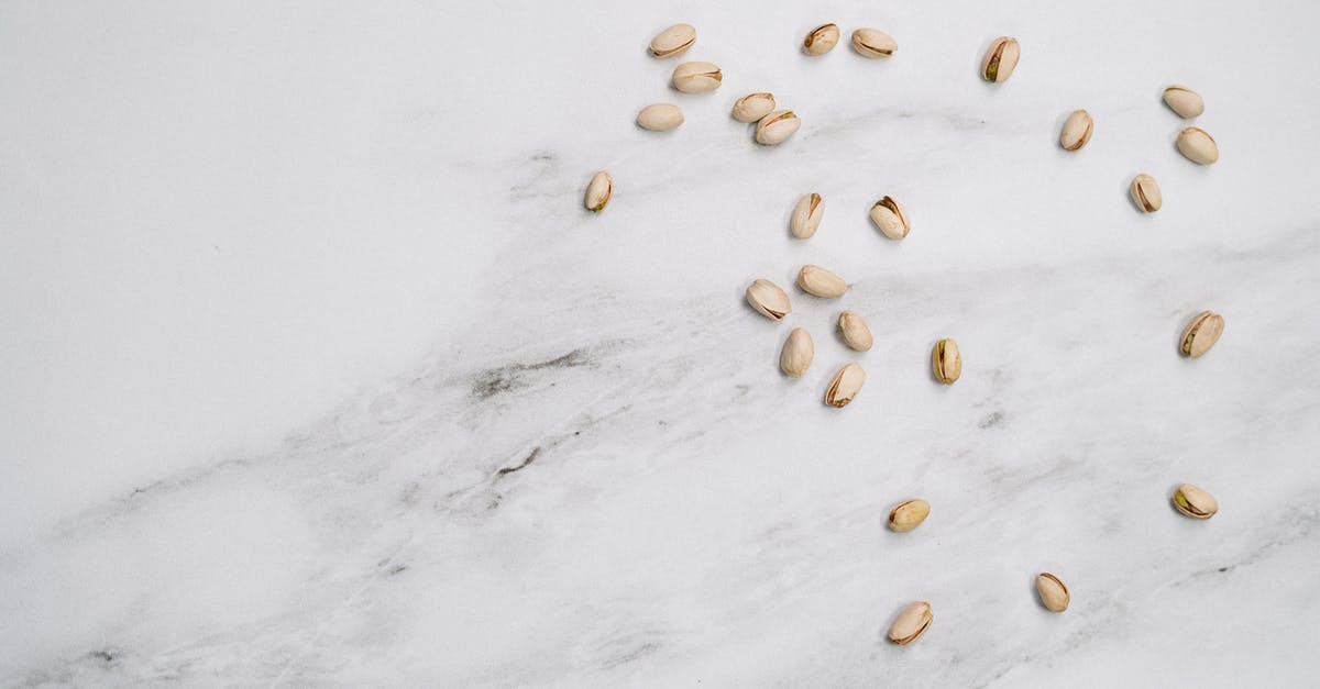 How do you shell groundnuts (peanuts) without breaking their kernels? - Pistachio On White Surface