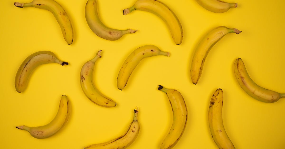 How do you stop banana flower soup from tasting astringent? - Top view of yummy ripe bananas placed at distance from each other on bright yellow background