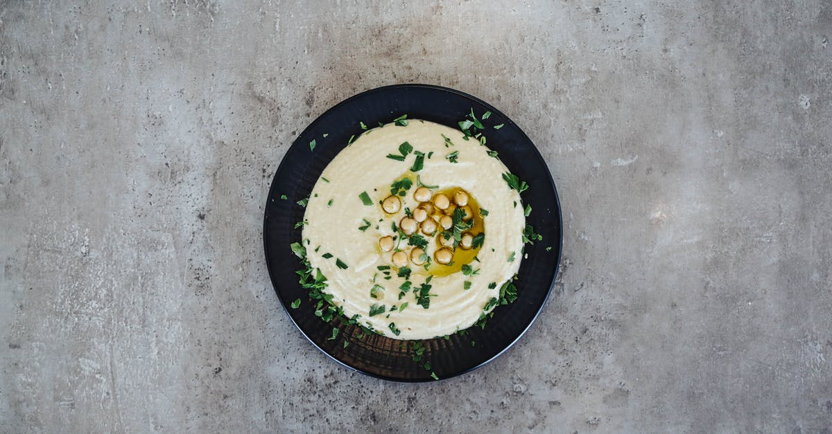 How do you stop chickpeas exploding in the microwave? - Chickpeas with Sauce on Black Plate 