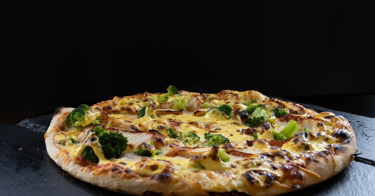 How does fast food restaurants make grilled chicken - Single chicken pizza on a black background