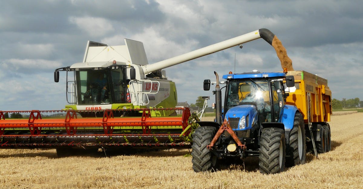 How does harvest time matter with tea? - Blue Tractor Next to White Farm Vehicle at Daytime